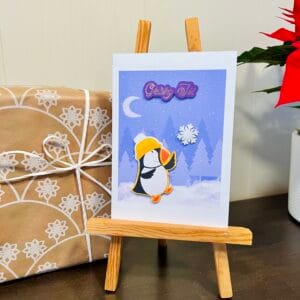 Puffin Reaching for a Snowflake in the Winter Forest